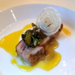 Suckling pig with pistachio beans, onions, O.J. and coriander