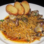 Fresh linguine Vongole with harissa broth and olive oil crostini