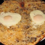Black truffle pizze with mozzarella and fried egg
