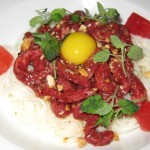 Raw Waygu beef with dried miso, sōmen noodle, peanut vinaigrette, candied watermelon and mint