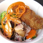 Traditional Vietnamese rice noodle salad with lemon grass chicken and chicken rice crispy rolls