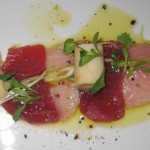 Hamachi crudo with truffle ponzu, charred green onion aioli and beignet de chanterelles