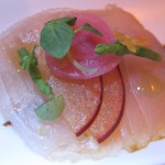 Yellowtail sashimi with fermented black garlic, pluots and shiso