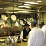 Chef Paul Prudhomme and crew hard at work behind the scenes at K-Paul's Louisiana Kitchen