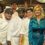 Chef Paul Prudhomme and his talented kitchen staff with Sophie Gayot