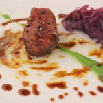 Roasted venison loin with red cabbage ginger-lychee compote, sweet potato and snap peas