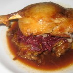 Duck confit with pommes lyonnaise, frisée and herb salad