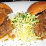 Duck confit sliders with orange gastrique and frisée salad