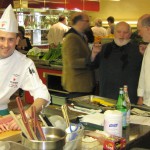Jean-Francois Daigle, preparing his dish. In the background, James Beard Vice President Mitchell Davis, chefs Michel Richard and Bob Hurley