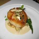 Roasted sea scallops on a bed of cauliflower purée, topped with toasted almonds