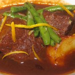 Braised beef short ribs with white wine and orange zest, served with haricots verts and fingerling potatoes