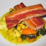 Sautéed pork belly with chickpeas, cavolo nero, cauliflower, saffron and orange