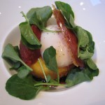 Soft-poached egg with crispy semolina dumpling, tomato compote, watercress and Serrano ham