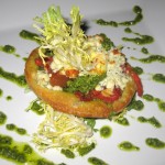 Tomato tarte Tatin: tomato confit, bosc pears, bleu cheese and frisee on puff pastry