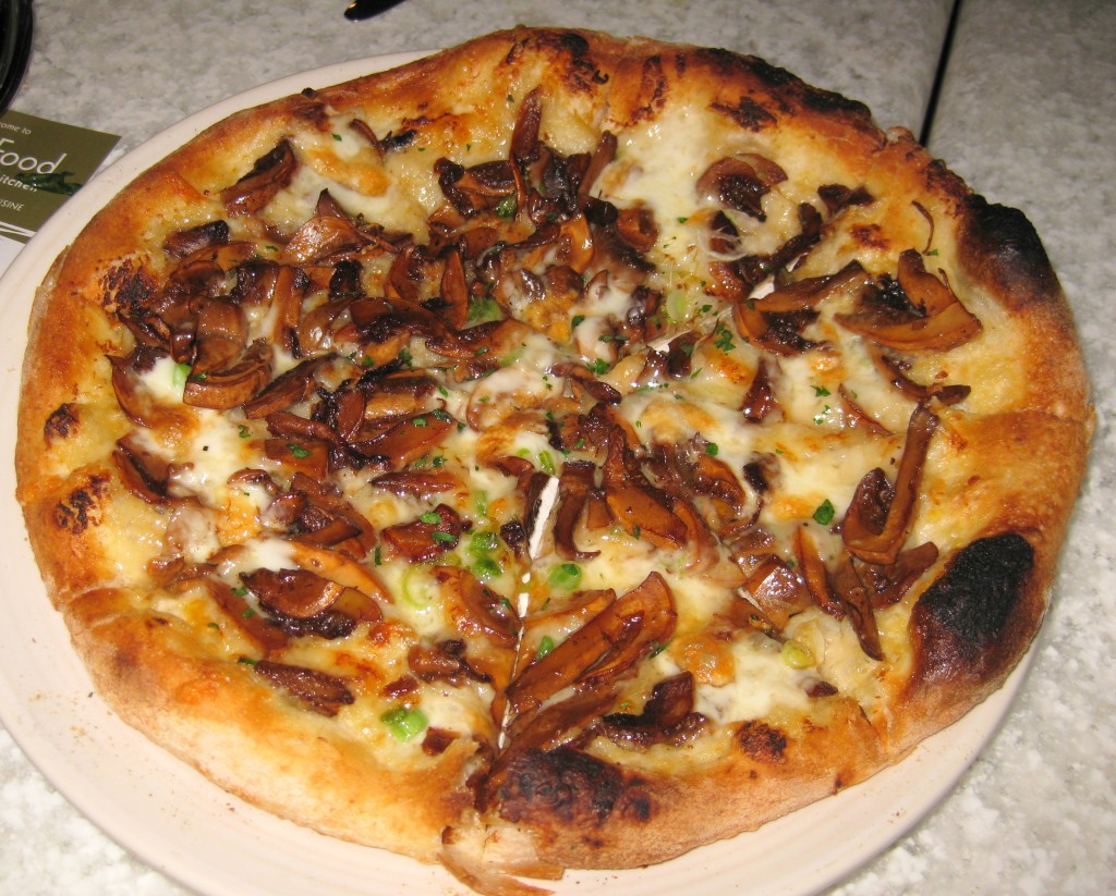 Almond cap mushroom pizza with spring garlic and Tallegio