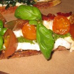 Crostini with tomato, pesto, ricotta, basil and balsamic