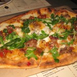 Sausage and egg pizza with pepper relish, scallions and Fresno chillies