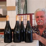 Bruce Perry signing bottles from his Papapietro Perry Winery