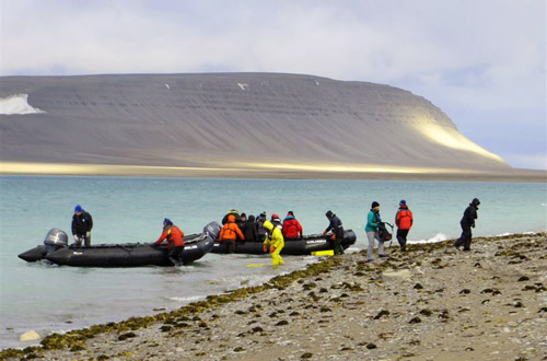 Zodiacs landing on stark tundra