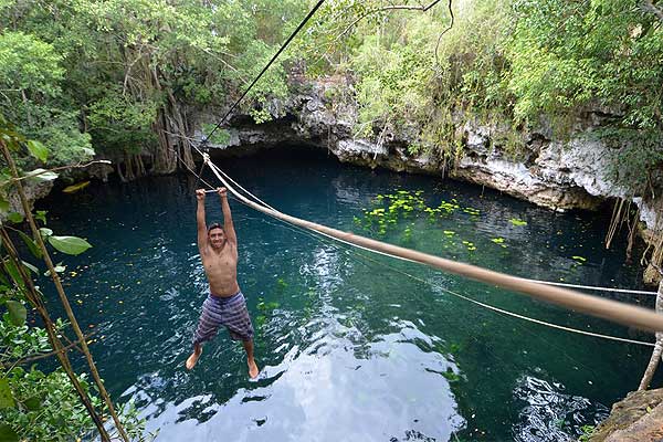 Zip-lining across a cenote near Puerto Morelos