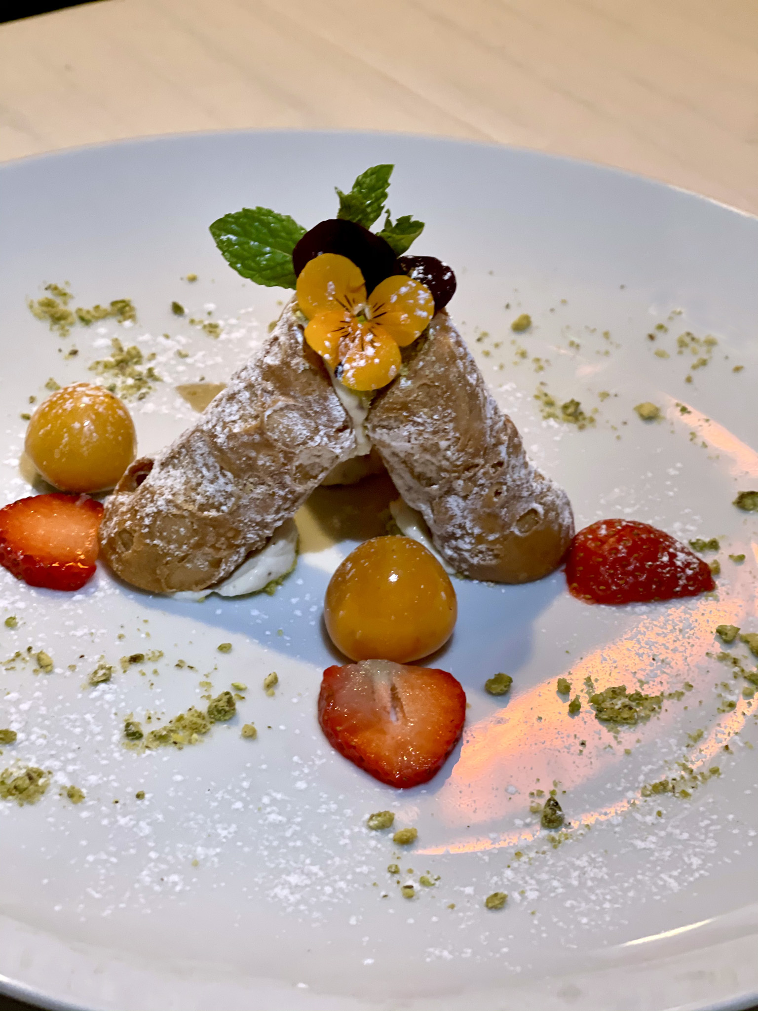Cannoli shell filled with pistachios and ricotta cheese