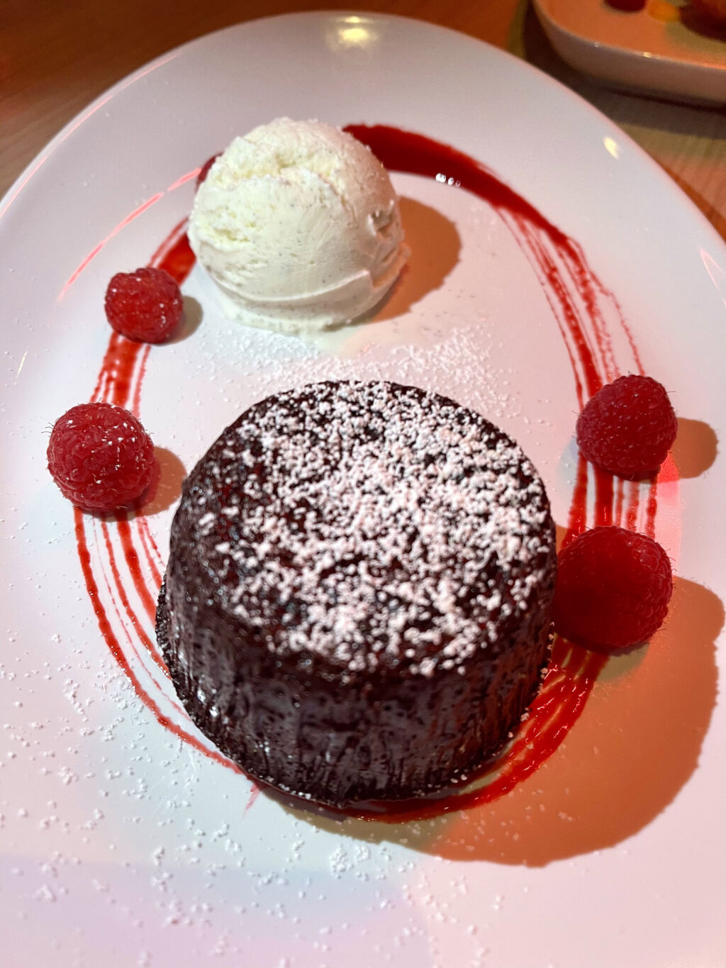 Molten chocolate cake, fresh raspberries, tahitian vanilla ice cream